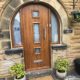 dark wood front door with three glass panes down the middle