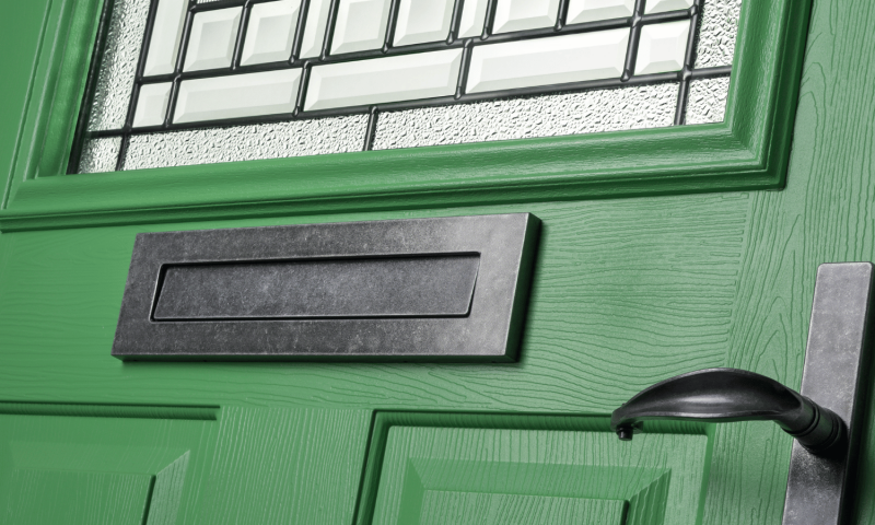 Solidor Pistachio green door with black letter plate and lever handle
