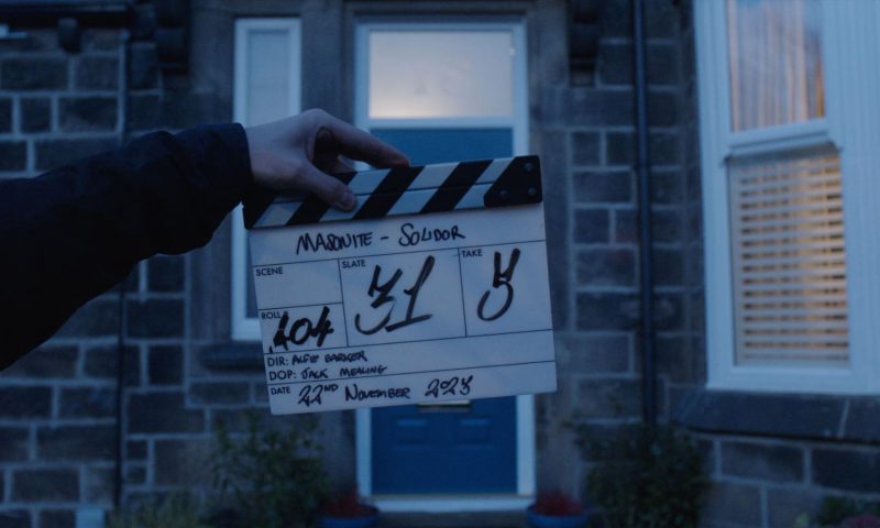 Clapperboard in front of Peacock Blue Solidor