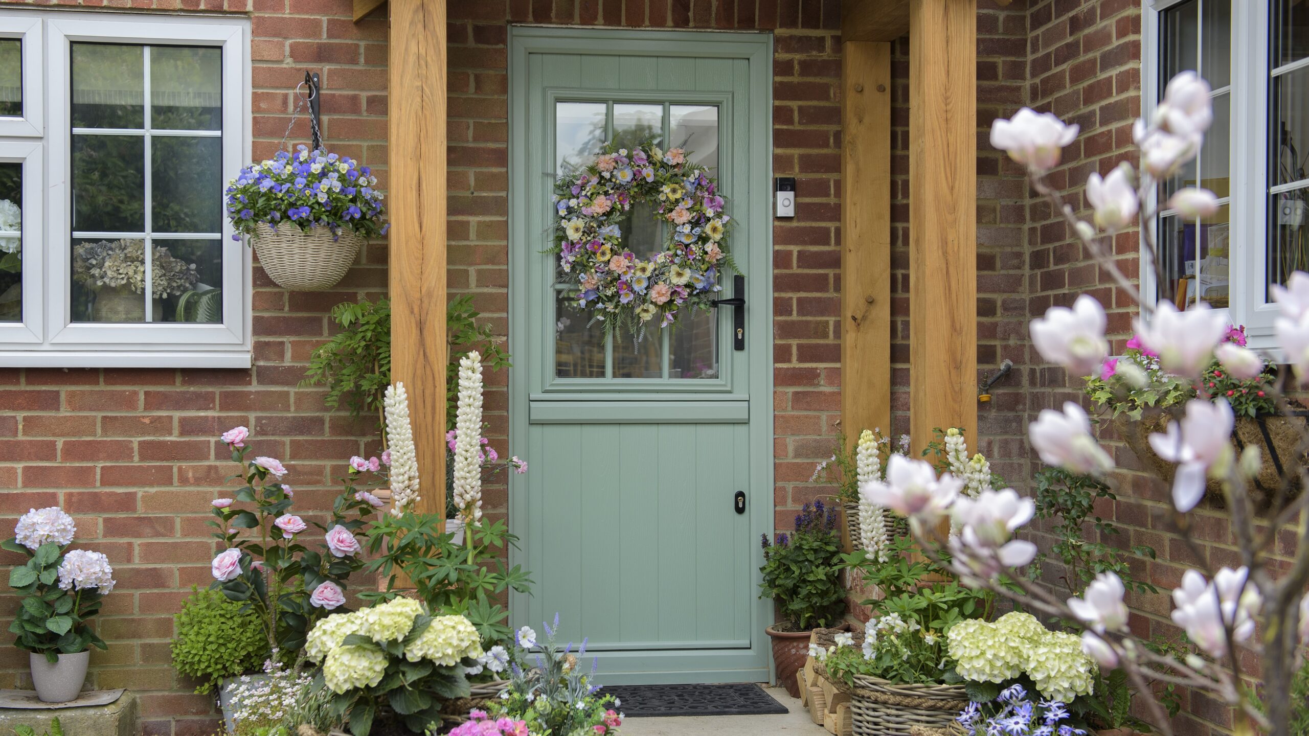 Aimee's Flint Beeston Composite Stable Door in Chartwell Green with summer wreath